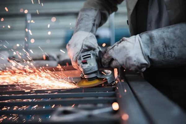 Worker operating an angle grinder