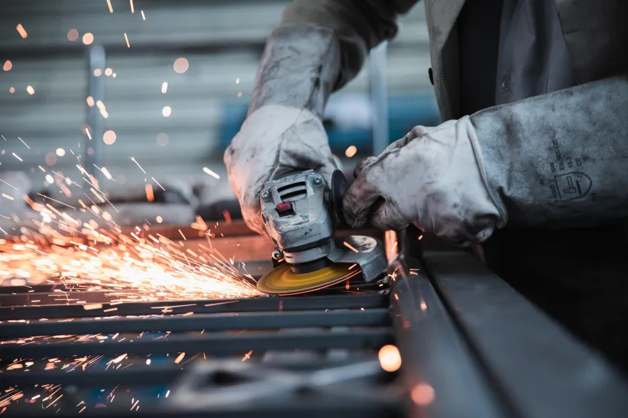 Worker operating an angle grinder